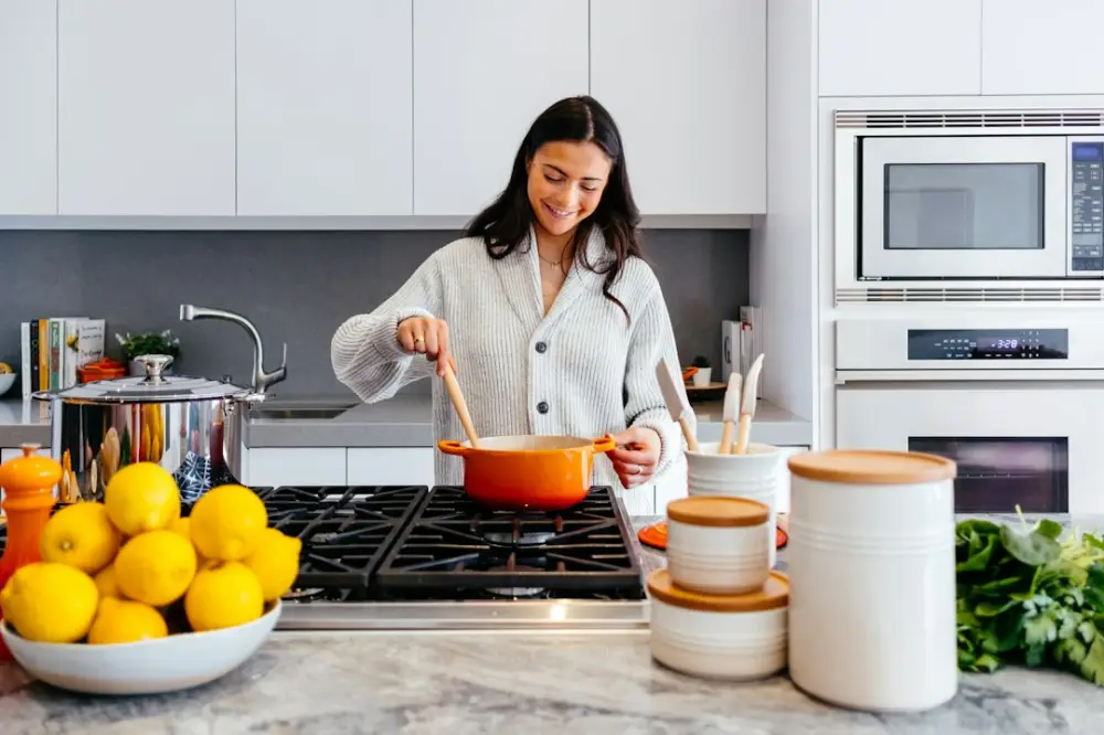 Woman cooking inside kitchen room, illustrating balancing heat in everyday cooking